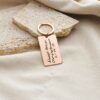 "Pack of 3 engraved stainless steel keychains with personalized designs."