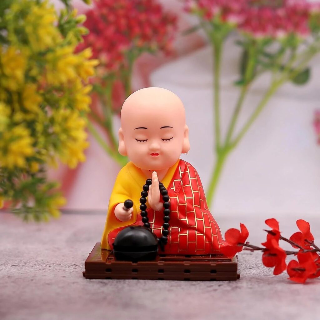 Solar-powered sitting Buddha statue with moving hands and head for dashboard or home decor