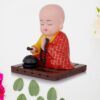 Solar-powered sitting Buddha statue with moving hands and head for dashboard or home decor