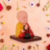 Solar-powered sitting Buddha statue with moving hands and head for dashboard or home decor