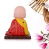 Solar-powered sitting Buddha statue with moving hands and head for dashboard or home decor